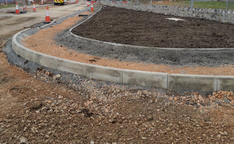 An image of kerbs being installed on a construction site