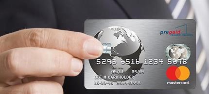 A hand holding a silver credit card with the mastercard logo and a pre-paid symbol on it