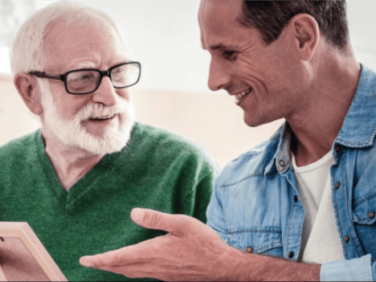 young man talking to elderly man
