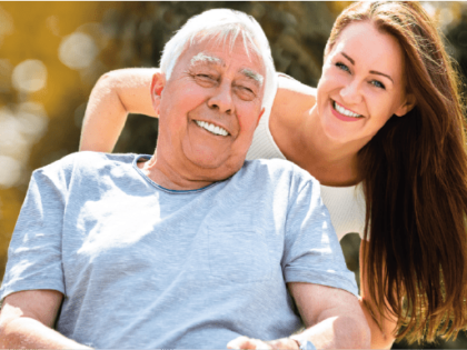young woman looking after older male