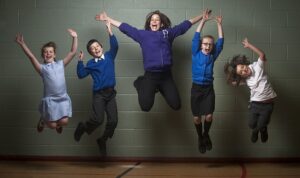 a group of children jumping in the air