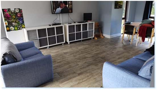 Lounge area of children's home with tv and sofas