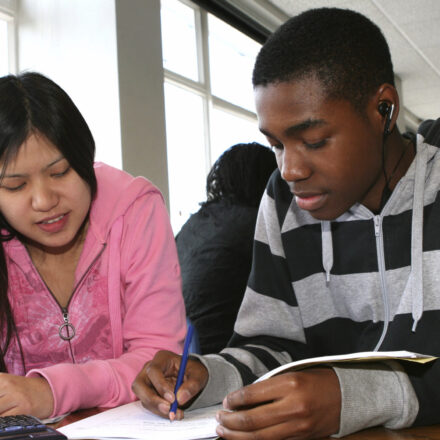 Two young people working together in a school classroom