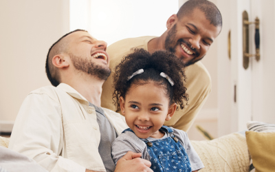 two men and a young girl laughing