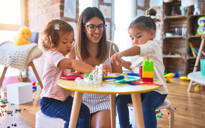 young women playing with children