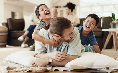 Man and young children playing on the floor