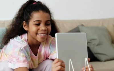 young girl playing on an ipad