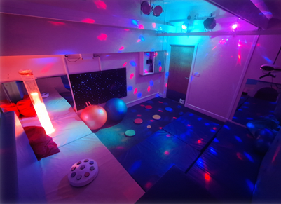 A darkened room with multi-coloured lights.