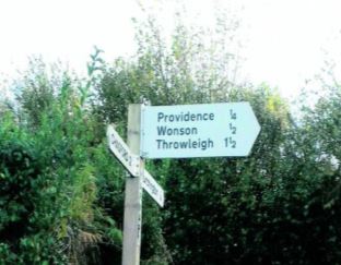 White road sign in the countryside