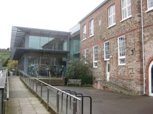 photo of the mansion totnes,modern building with large glass windows and a hand rail and path for ease of access