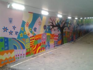 brightly colours mural in a subway