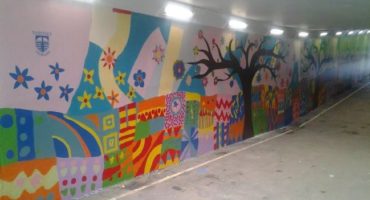 brightly colours mural in a subway