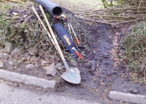 side of road, with tools and a drrainage pipe