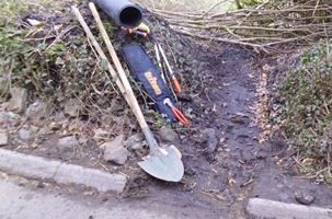 side of road, with tools and a drrainage pipe