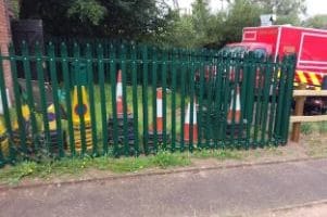 traffic cones stacked behind railings