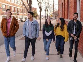 young people walking down a street