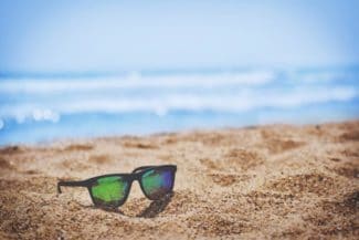 sunglasses on a sandy beach