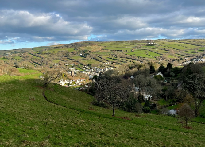 Image of a village surrounded by steep sided hills