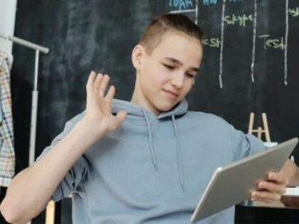 young teen boy using a tablet