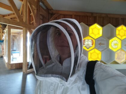 Woman taking a selfie wearing a bee keeping suit