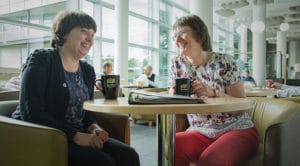 Mary Sherwood pictured with fellow dementia carer in Met Office canteen