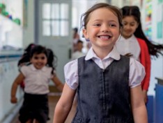 Young children in school uniform smiling