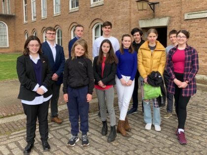 a picture of the youth counil young people outside of a building