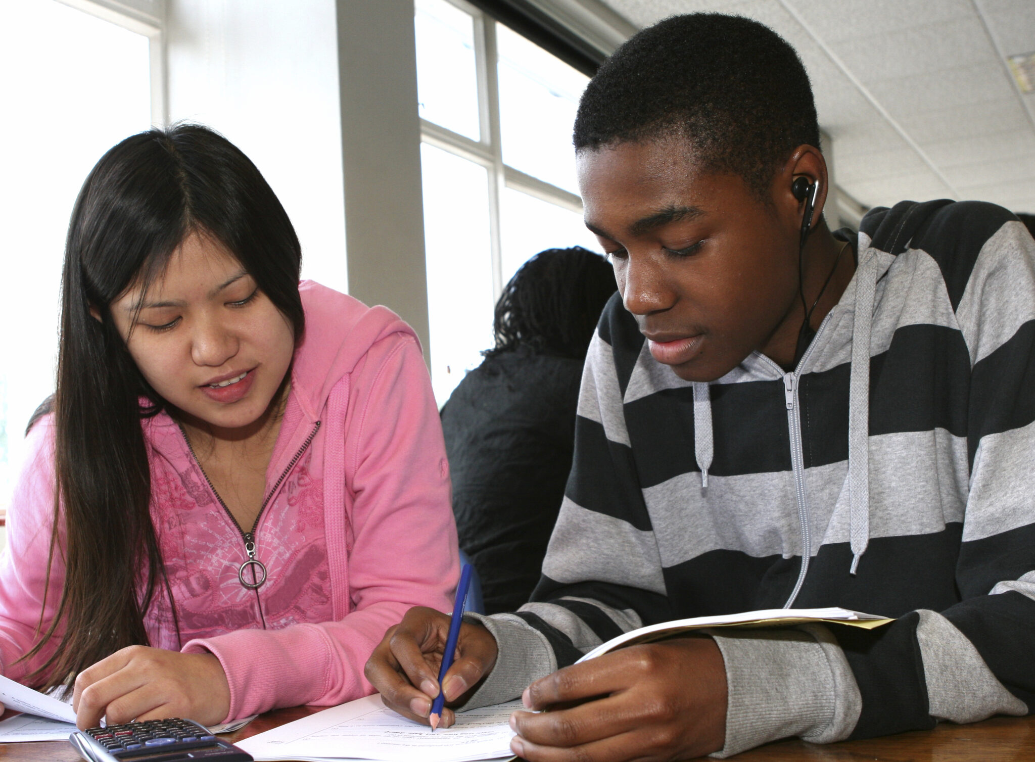 Two young people working together in a school classroom