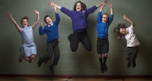 a group of children jumping in the air