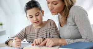 A mum helping her child with schoolwork