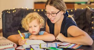 A mum helping her child with schoolwork