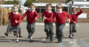 Young children running in a school playground