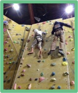 Climbing wall with young people climbing up