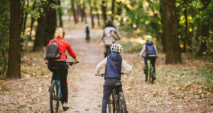 a family riding bikes through a forest