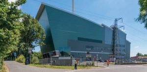 Energy from waste building, looks like a large factory building with a chimney and pylon close by