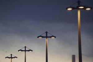 Row of streetlights with a dark grey sky in background