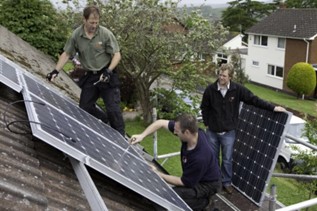 Solar panel installation on a roof of house, by 3 men