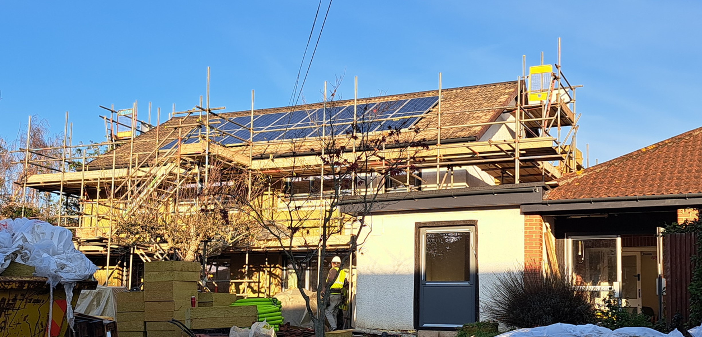 External wall insulation and PV panels fitted to a DCC building