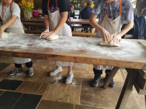 children and young people helping to prepare the food at their HAF schemes