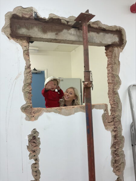 A child at Puffins nursery peeping through the new doorway.