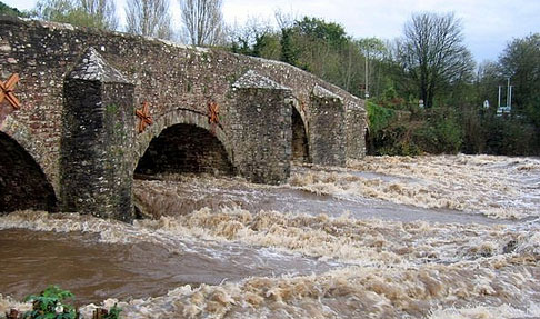 Water going under a bridge showing Bickleigh floods