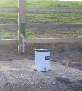 Hydro Logic rain gauge and transponder in a field 