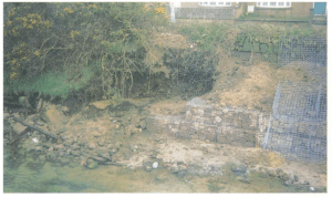 Installation of gabions on an eroding bank wall