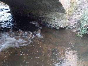 Photo of an undermined bridge in need of repair