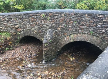 A photo showing the build-up material post event under the Bridge over the River Tale, Broadhembury.