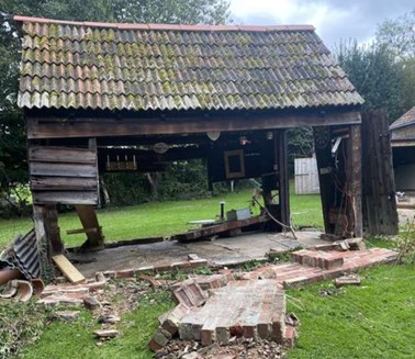 A photo showing an outbuilding that was washed out by the Millbrook and a major contributing factor to the blocking of the Chard Road/Stoney Lane Culvert.