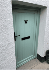 A green flood door on a building