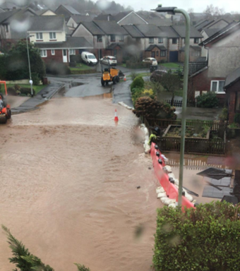 A road flooded with brown flood water
