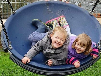 Children having fun at children's play park smiling