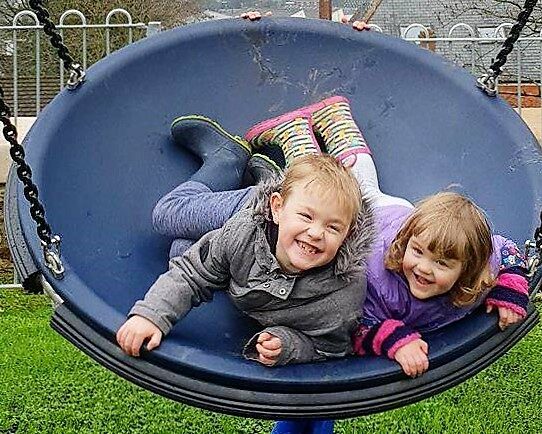 Children having fun at children's play park smiling
